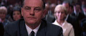 Movie still from “Hoffa” (1992), directed by Danny DeVito – A person wearing a suit and tie; Close Up shot, Low angle