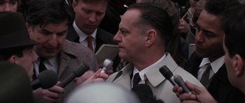 Movie still from “Hoffa” (1992), directed by Danny DeVito – A person talking on a microphone; Close Up shot, Over the shoulder angle