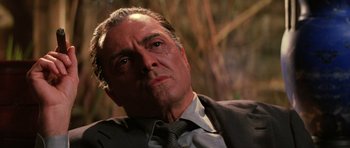 Movie still from “Hoffa” (1992), directed by Danny DeVito – An older man in a suit and tie looking into the distance; Close Up shot, Low angle