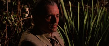 Movie still from “Hoffa” (1992), directed by Danny DeVito – A person wearing a suit and tie; Close Up shot, Low angle