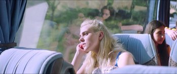 Movie still from “Holiday” (2018), directed by Isabella Eklöf – A woman sitting in a car while talking on the phone; Close Up shot, Over the shoulder angle