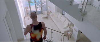 Movie still from “Holiday” (2018), directed by Isabella Eklöf – A man standing on the stairs of a living room; Wide shot, Overhead angle