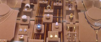 Movie still from “Holiday” (2018), directed by Isabella Eklöf – Many different types of jewelry on display; Extreme Close Up shot, Overhead angle