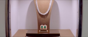 Movie still from “Holiday” (2018), directed by Isabella Eklöf – A necklace and earrings on a stand; Extreme Close Up shot, Overhead angle