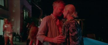 Movie still from “Holiday” (2018), directed by Isabella Eklöf – A man and a woman are kissing at a party; Close Up shot, Low angle