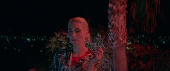 Movie still from “Holiday” (2018), directed by Isabella Eklöf – A young woman is smoking a cigarette outside at night; Close Up shot, Over the shoulder angle