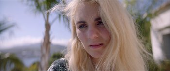 Movie still from “Holiday” (2018), directed by Isabella Eklöf – A person with long blonde hair; Close Up shot, High angle