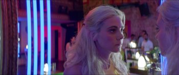 Movie still from “Holiday” (2018), directed by Isabella Eklöf – A woman with long blonde hair looking to her left; Close Up shot, Over the shoulder angle