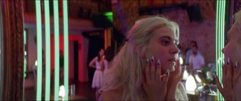 Movie still from “Holiday” (2018), directed by Isabella Eklöf – A woman with long blonde hair and blue nail polish talking on a cell phone; Close Up shot, Over the shoulder angle