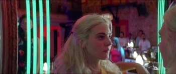 Movie still from “Holiday” (2018), directed by Isabella Eklöf – A woman with long blonde hair looking to her left; Close Up shot, Over the shoulder angle