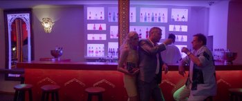 Movie still from “Holiday” (2018), directed by Isabella Eklöf – A man and a woman taking a selfie in a bar; Medium shot, Low angle