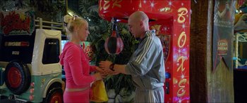 Movie still from “Holiday” (2018), directed by Isabella Eklöf – A man and a woman holding hands in front of a punching bag; Medium shot, Over the shoulder angle