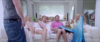 Movie still from “Holiday” (2018), directed by Isabella Eklöf – A group of people sitting on top of a white couch; Wide shot, High angle