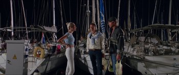 Movie still from “Holiday” (2018), directed by Isabella Eklöf – A group of people standing next to each other on a boat; Wide shot, Over the shoulder angle