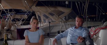Movie still from “Holiday” (2018), directed by Isabella Eklöf – A man and a woman sitting next to each other on a boat; Medium shot, Over the shoulder angle