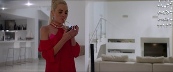 Movie still from “Holiday” (2018), directed by Isabella Eklöf – A woman in a red dress smoking a cigarette; Medium shot, Over the shoulder angle