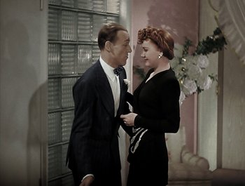 Movie still from “Holiday Inn” (1942), directed by Robert Allen – A man and a woman standing next to each other; Medium shot, High angle