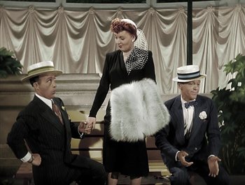 Movie still from “Holiday Inn” (1942), directed by Robert Allen – A group of people sitting on a bench wearing hats; Wide shot, High angle