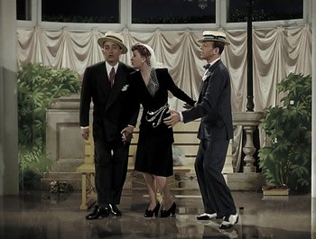 Movie still from “Holiday Inn” (1942), directed by Robert Allen – A group of men and a woman standing next to each other; Wide shot, High angle