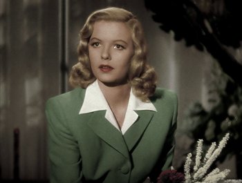 Movie still from “Holiday Inn” (1942), directed by Robert Allen – A woman in a green suit and white shirt; Close Up shot, Low angle