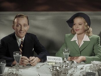 Movie still from “Holiday Inn” (1942), directed by Robert Allen – A man and a woman sitting at a table; Medium shot, High angle