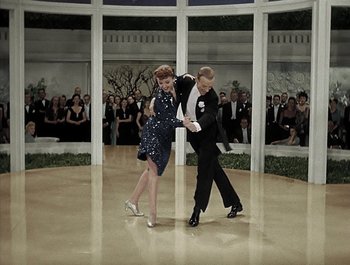 Movie still from “Holiday Inn” (1942), directed by Robert Allen – A couple of people that are dancing in a room; Wide shot, High angle