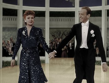 Movie still from “Holiday Inn” (1942), directed by Robert Allen – A man and a woman holding hands while dancing in formal wear; Medium shot, Low angle