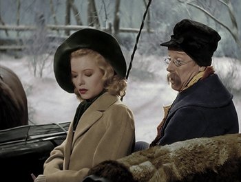 Movie still from “Holiday Inn” (1942), directed by Robert Allen – A man and a woman sitting next to each other in the snow; Medium shot, Over the shoulder angle