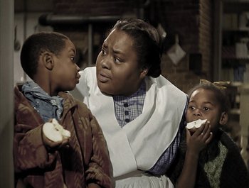 Movie still from “Holiday Inn” (1942), directed by Robert Allen – A group of people that are eating some food together; Medium shot, Over the shoulder angle
