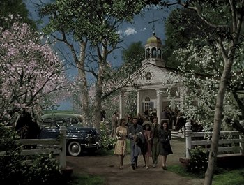 Movie still from “Holiday Inn” (1942), directed by Robert Allen – A group of people walking in front of a building; Extreme Wide shot, High angle