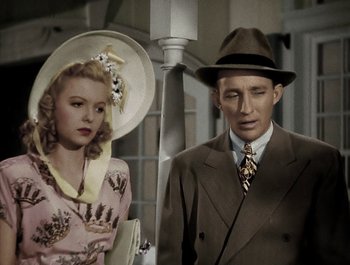 Movie still from “Holiday Inn” (1942), directed by Robert Allen – A man and a woman standing next to each other; Medium shot, High angle