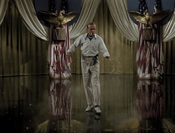 Movie still from “Holiday Inn” (1942), directed by Robert Allen – A man in a white shirt and a bow tie; Wide shot, Low angle