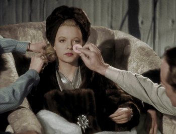 Movie still from “Holiday Inn” (1942), directed by Robert Allen – A woman in a fur coat is getting her makeup done; Close Up shot, Over the shoulder angle