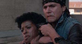 Movie still from “Hollywood Shuffle” (1987), directed by Robert Townsend – A man and a woman are standing next to each other; Close Up shot, Low angle