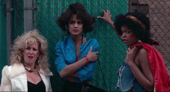 Movie still from “Hollywood Shuffle” (1987), directed by Robert Townsend – A group of women standing next to each other near a chain link fence; Medium shot, Low angle