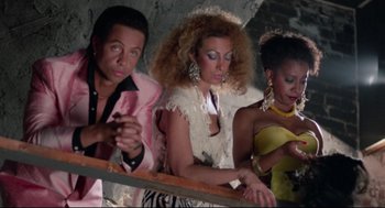 Movie still from “Hollywood Shuffle” (1987), directed by Robert Townsend – A group of people sitting next to each other; Medium shot, High angle