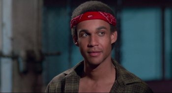 Movie still from “Hollywood Shuffle” (1987), directed by Robert Townsend – A man wearing a red bandanna is smiling for the camera; Close Up shot, Low angle