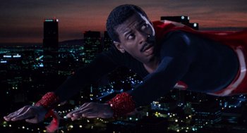 Movie still from “Hollywood Shuffle” (1987), directed by Robert Townsend – A man flying through the air over a city at night; Medium shot, Low angle