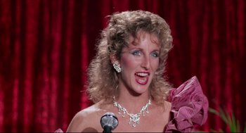 Movie still from “Hollywood Shuffle” (1987), directed by Robert Townsend – A person with a microphone wearing a necklace; Close Up shot, High angle