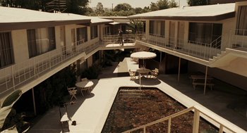 Movie still from “Hollywoodland” (2006), directed by Allen Coulter – A courtyard with tables , chairs , and umbrellas in it; Extreme Wide shot, High angle