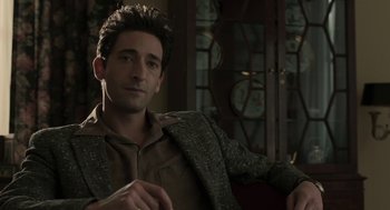 Movie still from “Hollywoodland” (2006), directed by Allen Coulter – A man sitting in a chair wearing a jacket; Medium shot, Over the shoulder angle