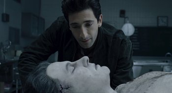 Movie still from “Hollywoodland” (2006), directed by Allen Coulter – A man looking down at the face of a dead person; Close Up shot, Over the shoulder angle