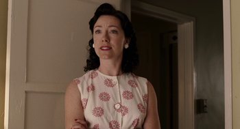 Movie still from “Hollywoodland” (2006), directed by Allen Coulter – A woman standing in front of a wall with her arms crossed; Medium shot, Low angle