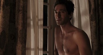 Movie still from “Hollywoodland” (2006), directed by Allen Coulter – A man standing in front of a window with no shirt on; Medium shot, High angle