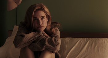 Movie still from “Hollywoodland” (2006), directed by Allen Coulter – A beautiful young woman sitting on a bed; Close Up shot, High angle