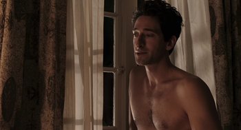 Movie still from “Hollywoodland” (2006), directed by Allen Coulter – A shirtless man standing in front of a window; Medium shot, Low angle