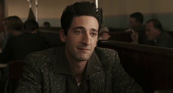 Movie still from “Hollywoodland” (2006), directed by Allen Coulter – A person wearing a suit and tie; Close Up shot, Over the shoulder angle