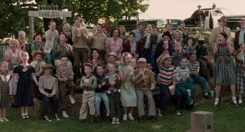 Movie still from “Hollywoodland” (2006), directed by Allen Coulter – A large group of people sitting in a field; Wide shot, High angle