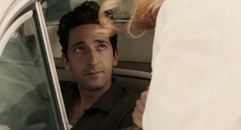 Movie still from “Hollywoodland” (2006), directed by Allen Coulter – A man sitting next to a woman in the back of a car; Close Up shot, Over the shoulder angle