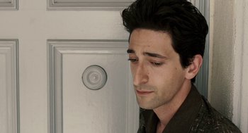 Movie still from “Hollywoodland” (2006), directed by Allen Coulter – A person wearing a black shirt near a wall; Close Up shot, High angle